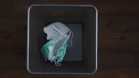 Throwing mask in the trash. Discarded surgical masks. Stock Footage 174291892