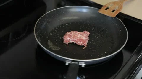 Throwing meat in the pan. Stock-Footage 10580038