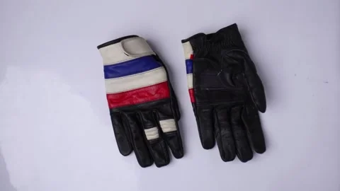 Throwing motorcycle gloves in hand isolated white background 库存影片 274468291