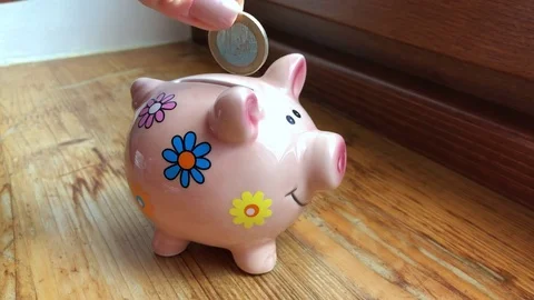 Throwing one euro into a pig money-box Stock Footage 85041908