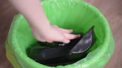 Throwing out black plastic containers from ready-made food into trash bag Stock Footage 153202457
