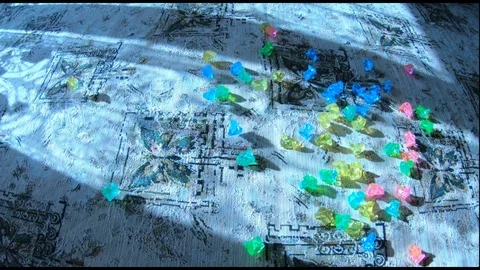 Throwing out transparent colored stones Stock Footage 86818797
