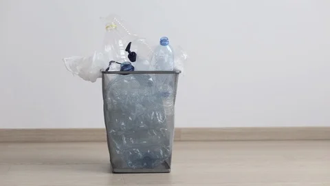 Throwing out used plastic bottles and packagings to trash bin Stock Footage 129978712