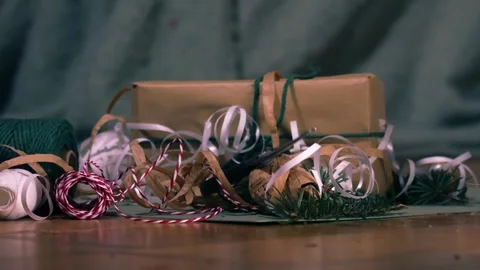Throwing pair of scissors on Christmas gift wrapping paper with green background Vídeo Stock 331247067