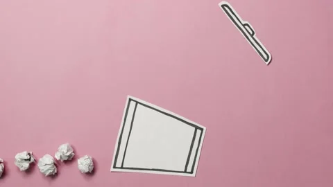 Throwing paper balls into the trash can. Stop motion and cut out animation. Stock Footage 137970310