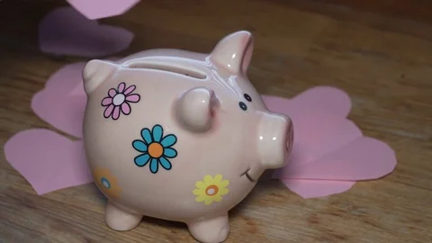 Throwing paper heart into moneybox Stock Footage 84773591