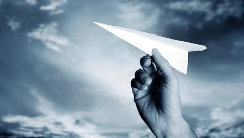 Throwing a paper plane.. Stock Photos
