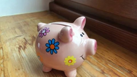 Throwing pink paper heart into a pig money-box Stock Footage 85042268