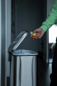 Throwing a plastic bottle into a large metal trash can. eco-friendly environment Stock Photos