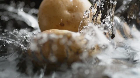 Throwing potato into boiling water. Slow Motion. Stock Footage 94081049