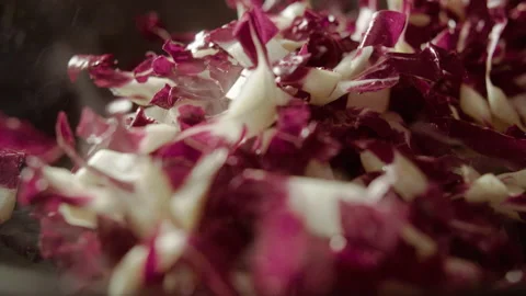 Throwing Radicchio (red chicory) into the pan Stock Footage 135081117