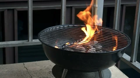 Throwing Raw Chicken onto Over Open Flame Charcoal Grill Stock Footage 132018470