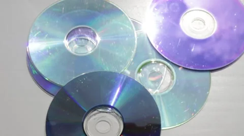Throwing reflected CD-discs on a table Vídeo Stock 66756629