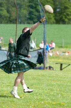 Throwing a rock high land games scotland Stock Photos