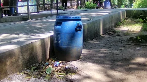 Throwing rubbish at bin Stock Footage 168086726