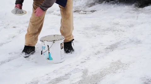 Throwing Salt On The Pathway In Winter Stock Footage 85099343