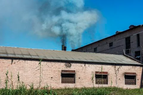 Throwing smoke by chimneys Stock Photos