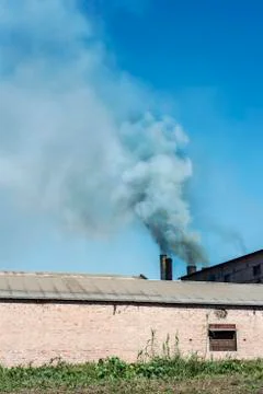 Throwing smoke by chimneys Stock Photos