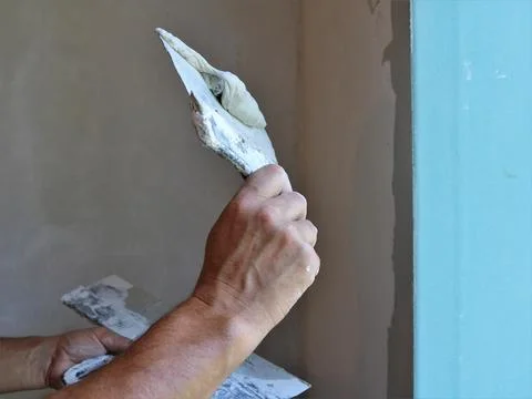 Throwing the solution on the slope of the window when leveling the corner Stock Photos