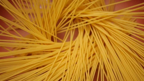 Throwing spaghetti pasta into a pan in slow motion Stock-Footage 140664763