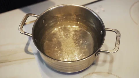 Throwing spaghetti pasta into water. Overhead shot. Stock Footage 102503712