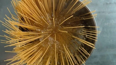 Throwing spaghetti pasta into water. Slow Motion. Stock Footage 94086583