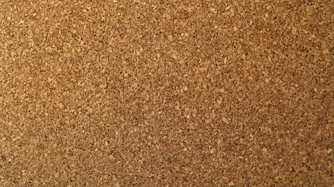 Throwing stickers into the cork board one piece at a time. The view is right on Stock Footage 202139916