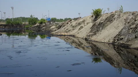 Throwing stone into the petroleum lagoon Stock Footage 59534147
