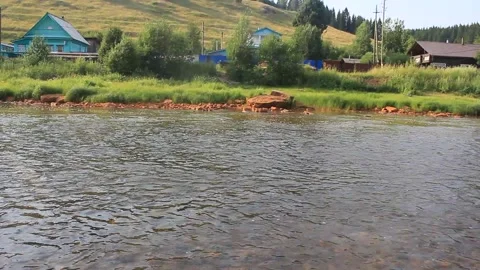 Throwing a stone into the river. Small forest river. Splashing water Stock Footage 142560629