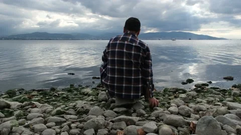 Throwing stones to sea Stock Footage 170906889