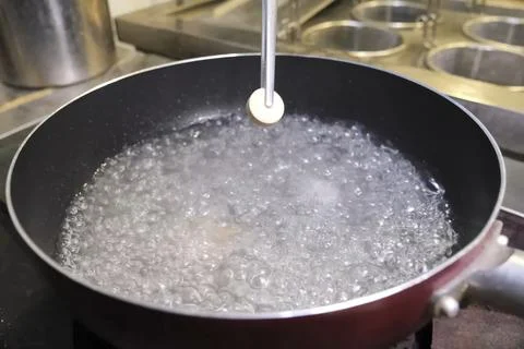 Throwing tablets with soup sublimate broth into boiling water. Fotos de archivo