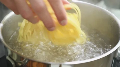 Throwing tagliatelle into boiling water. Stock Footage 177570898