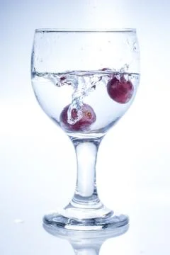 Throwing two grapes Stock Photos