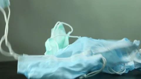 Throwing  used surgical masks on the table, in studio Chiangmai Thailand. Stock Footage 151955846