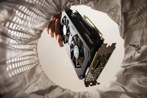 Throwing a video card in the trash bin, a computer video card in hand insid.. 写真素材