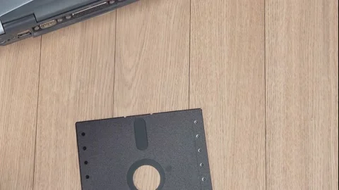 Throwing vintage 5.25 floppy discs into a pile. Obsolete computer technology. Stock Footage 149423976