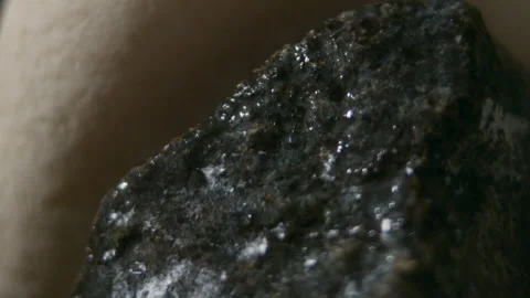 Throwing water on a stack of hot stones in the sauna stove, slow motion Video stock 254535697