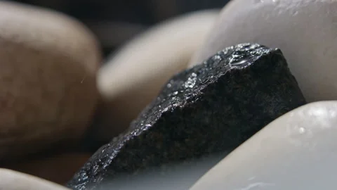 Throwing water on a stack of hot stones in the sauna stove, slow motion Video stock 254537933