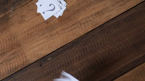 Throwing white paper with QUESTION MARK on wooden table Stock Footage 88468943