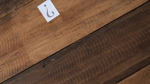 Throwing white paper with QUESTION MARK on wooden table Stock Footage 88468971