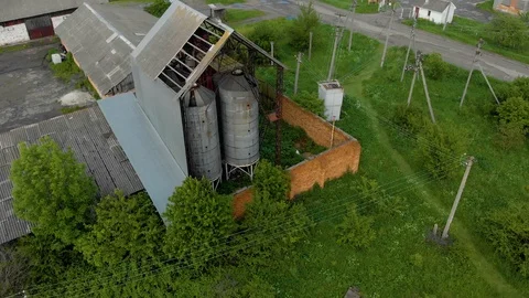 Thrown hangars, with an old metal tower water reservoirs aerial background Stock Footage 108433875