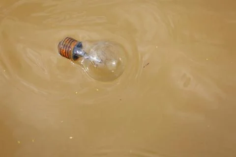 Thrown the old bulb into river Stock-Fotos