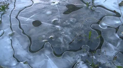 Thrown Stone Impacting Patterned Ice Stock Footage 21375208