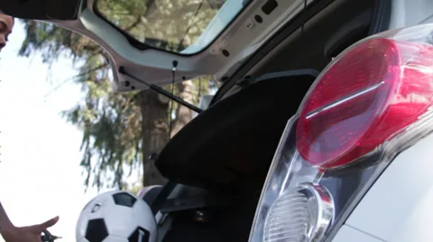 Throws ball into the trunk of Chevy spark Stock Footage 36240942