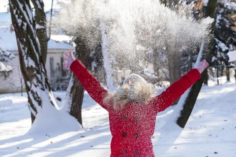Throws snow up.child in the winter Stock Photos