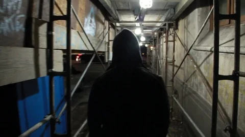 Thug casually walks down sidewalk Stock Footage 77614041