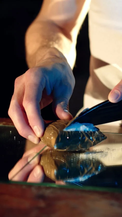 A thug is cutting a package with drugs on the table by knife.  Stock Footage 300674068