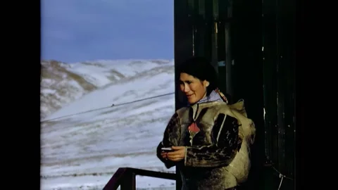 THULE - 1954 - An Indigenous Inughuit Eskimo holds her baby and an older woman Stock Footage 331068164