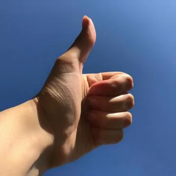 Thumb up on a blue background, like Stock Photos