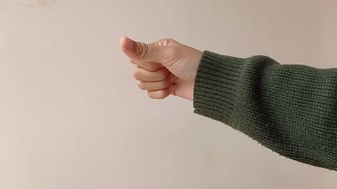 Thumb down with a green sweater Stock Footage 150599249